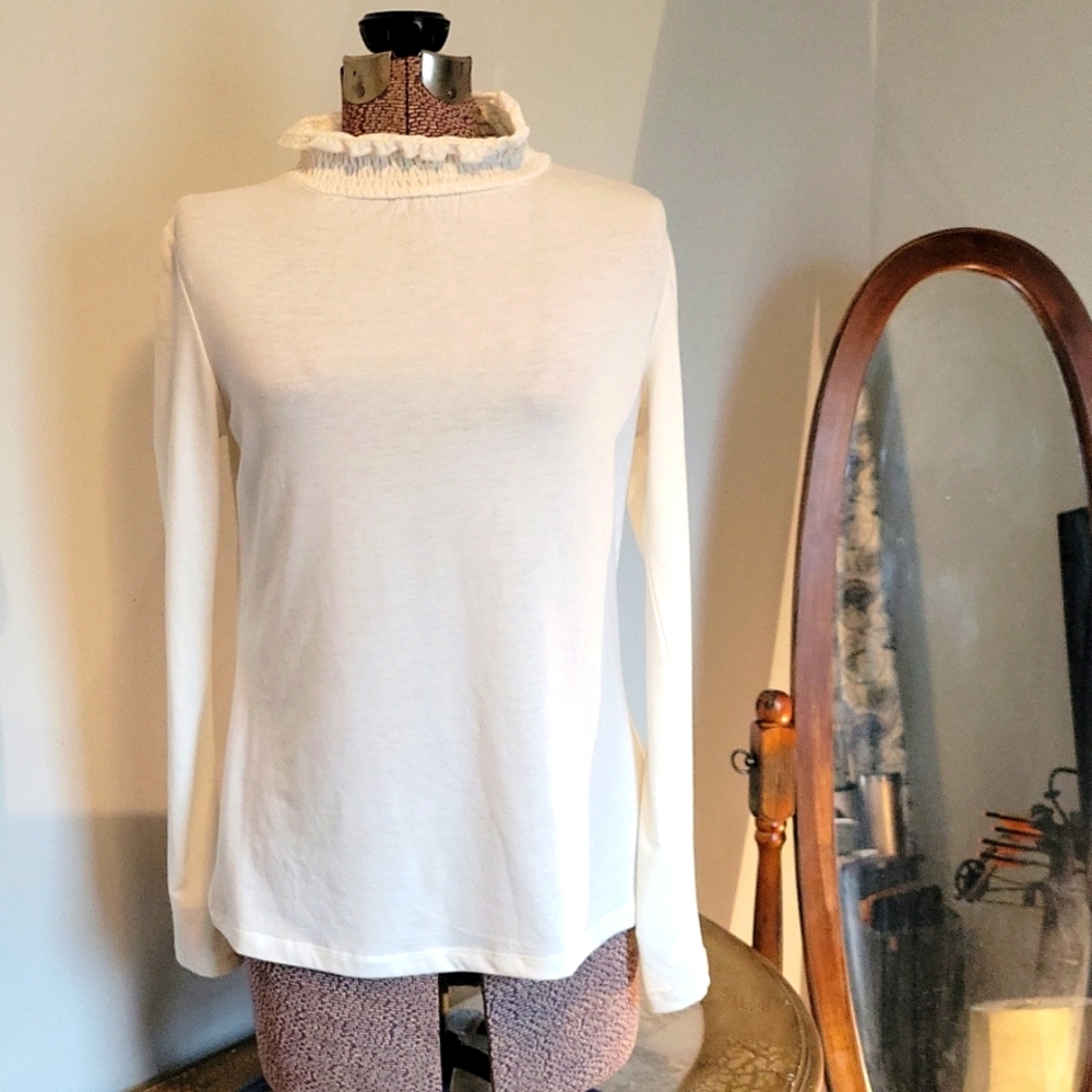 Cream color long sleeve mick turtle neck blouse.